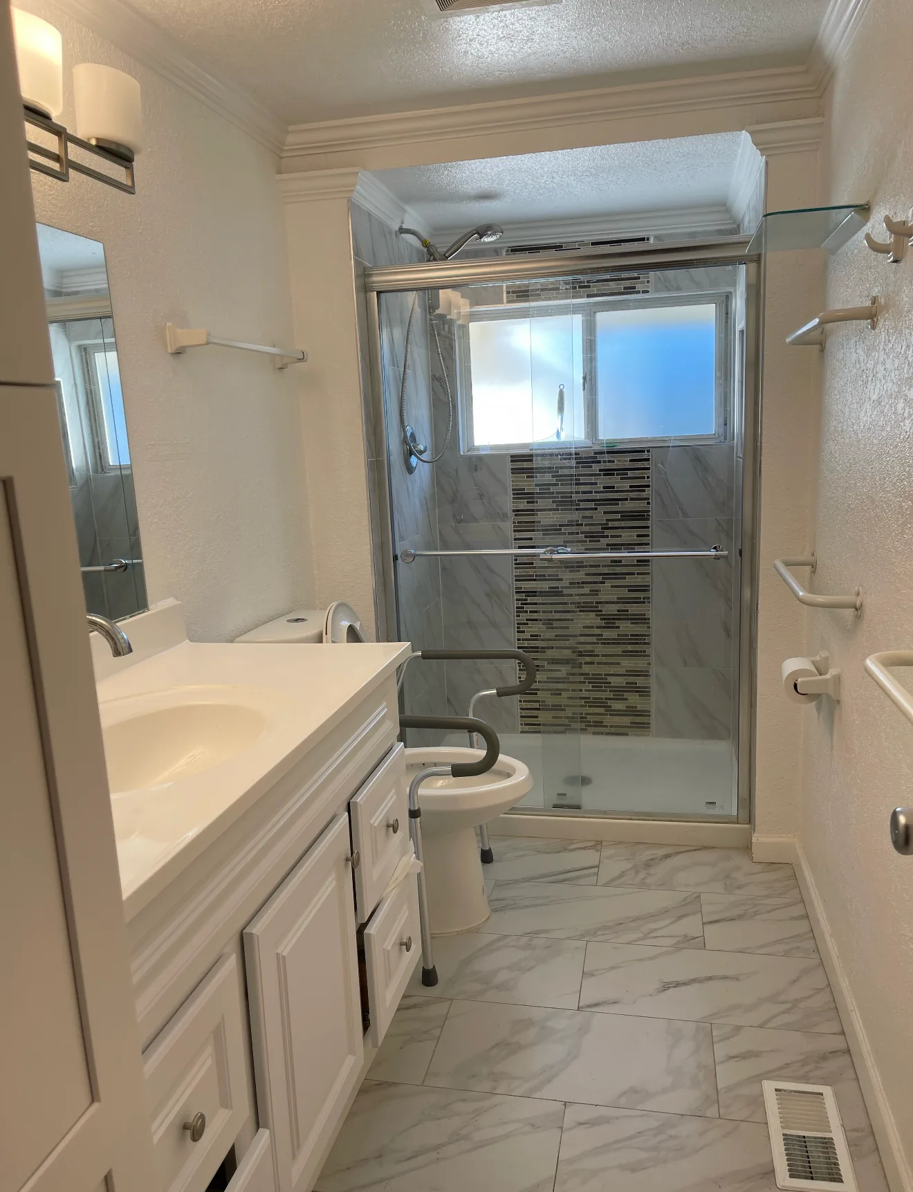 Step-free shower with grab rails in the accessible bathroom at Birdsong Adult Family Home, Kent WA
